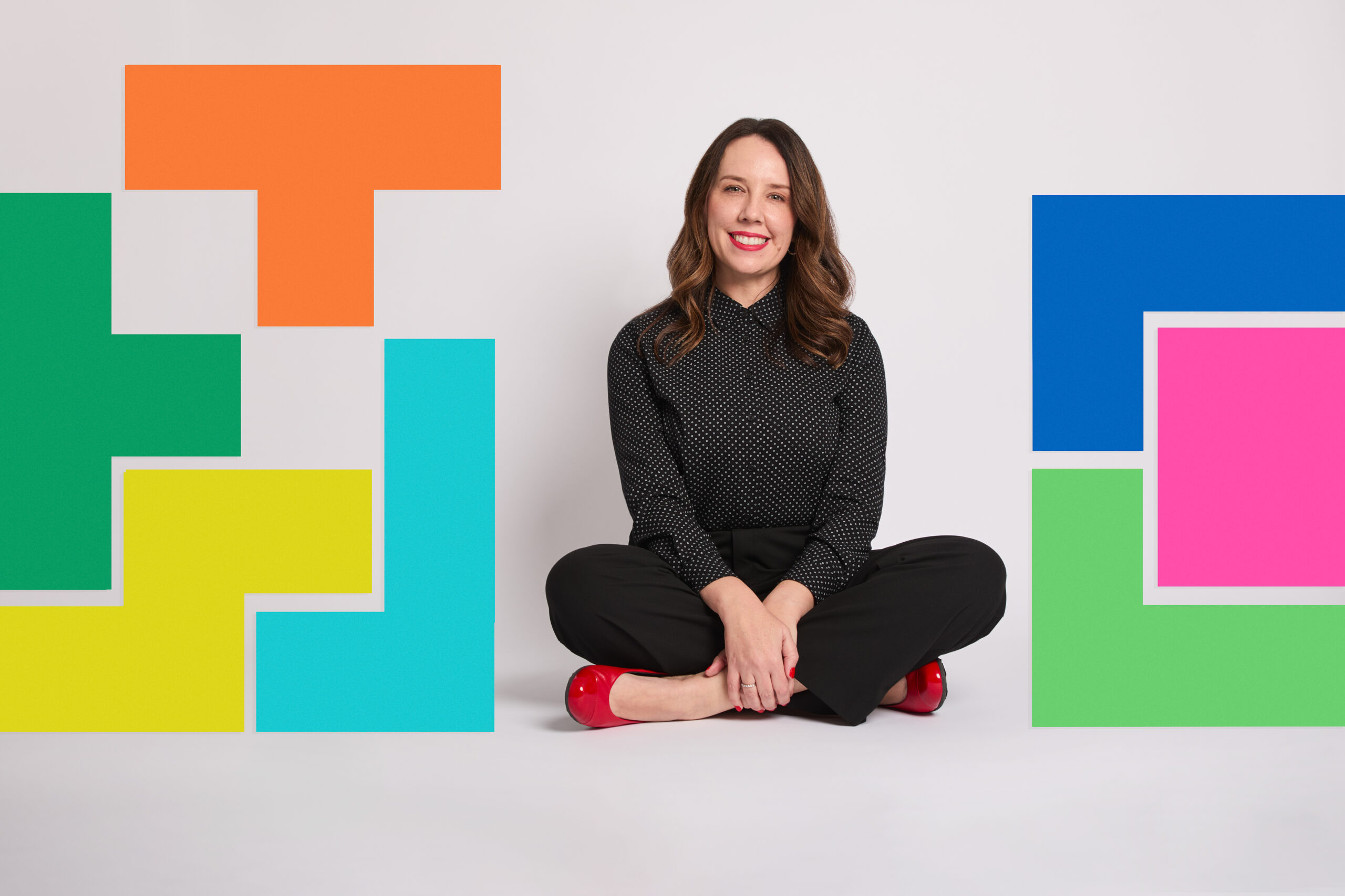Woman in black with red shoes, geometric shapes